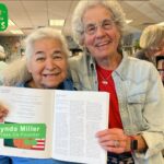 Grae McCullough with Lynda Miller holding up their book