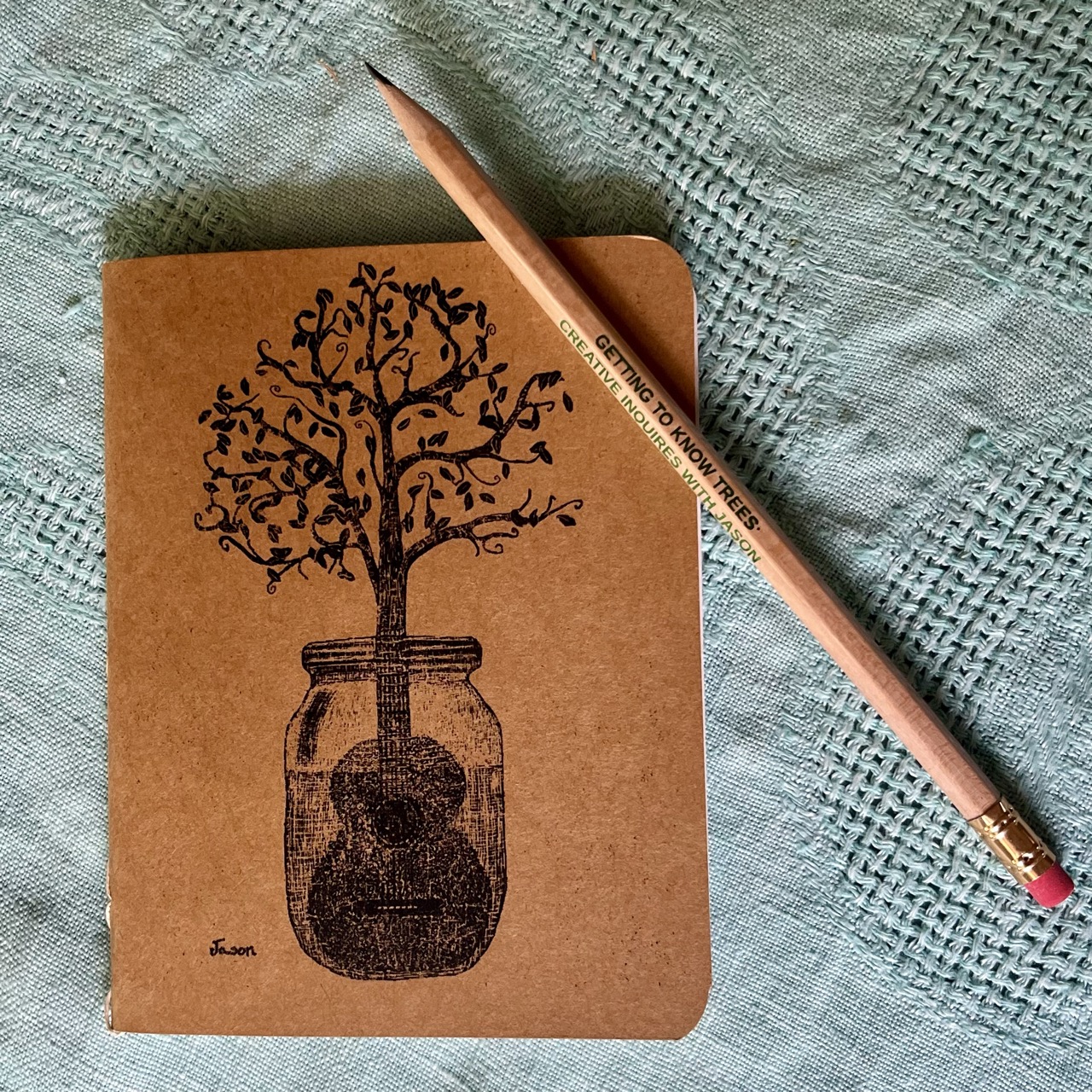 Closed notebook with a pencil